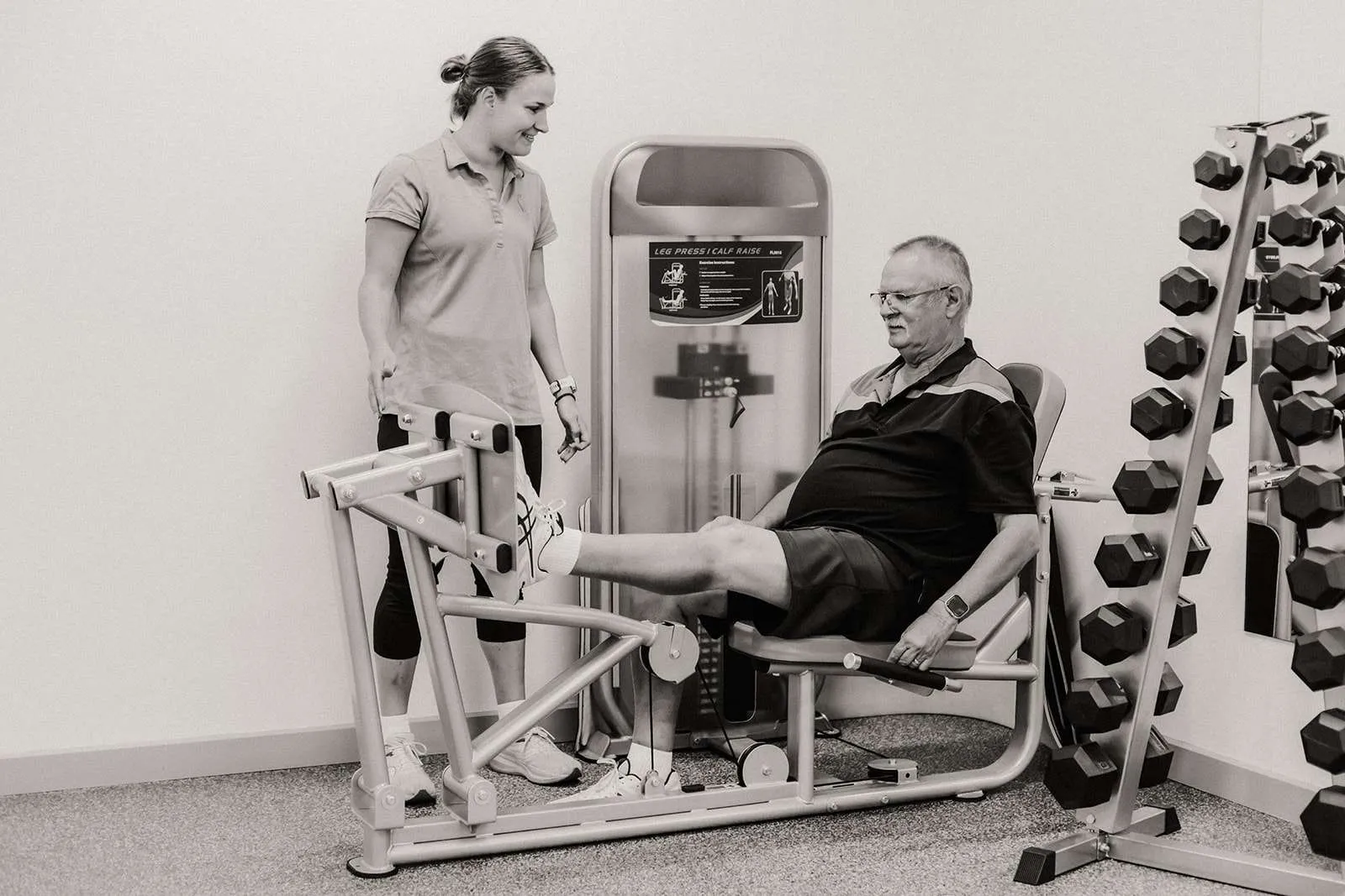 An exercise physiologist working with a patient in the clinic gym